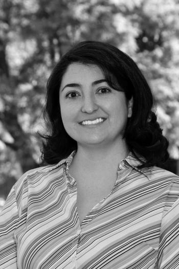 Pamela Martinez outside with trees behind her