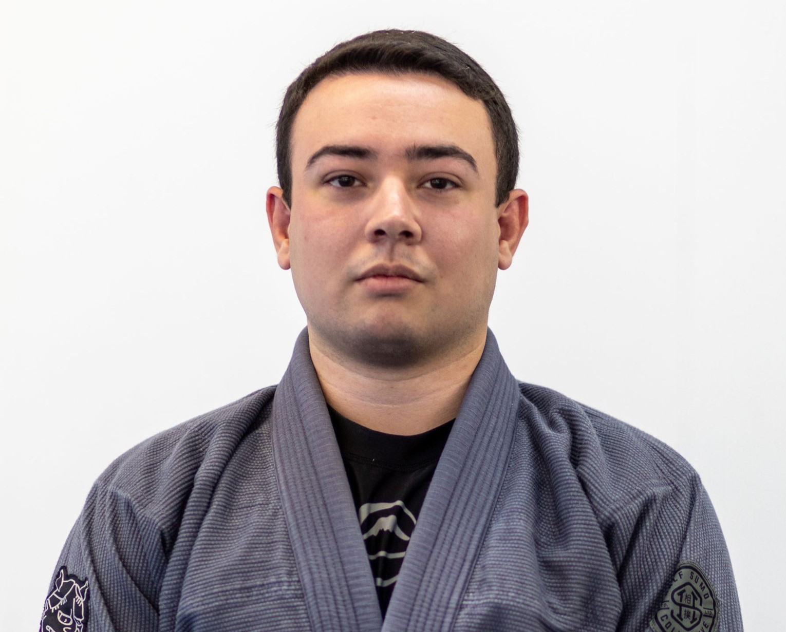 Headshot of Victor Baquera in a gray martial arts robe.